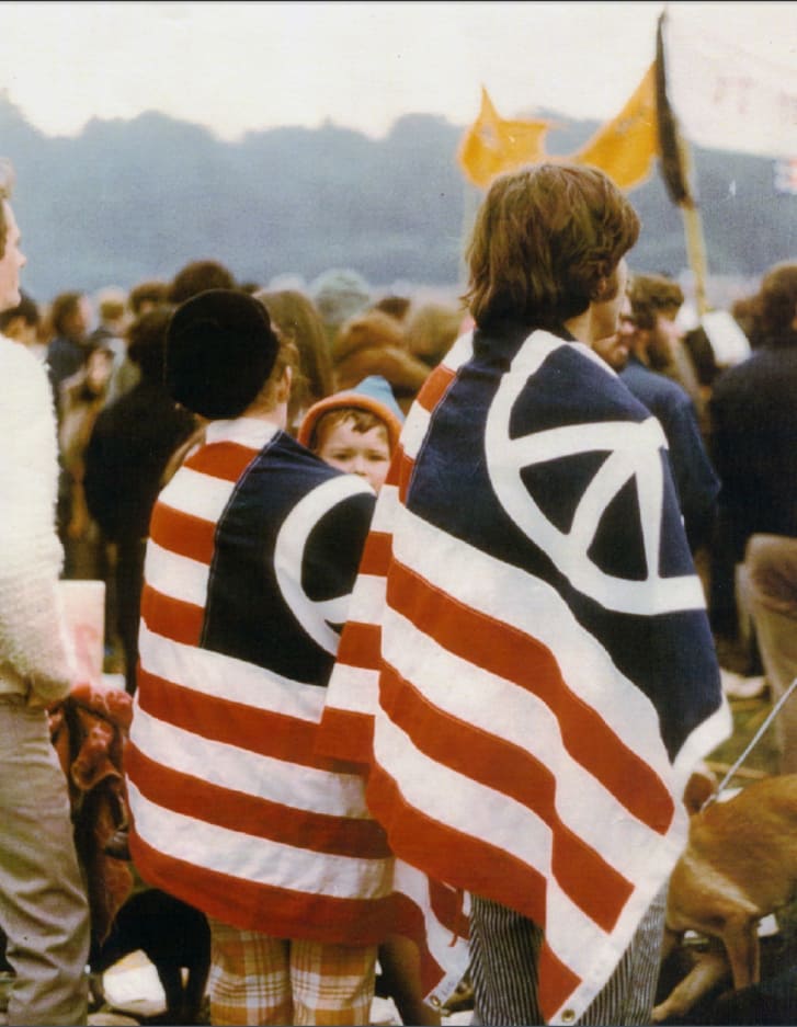 A couple wears an American flag modified with the peace symbol in an anti-Vietnam war  protest in San Fracisco on Nov. 15, 1969.